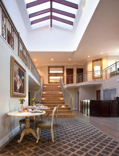 a living room with a skylight and stairs at Hermanus Boutique Guest House in Hermanus