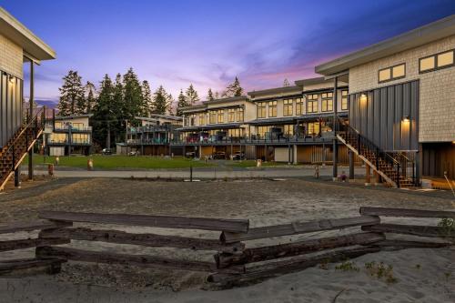 a group of buildings in a park at dusk at Seas The Day Saratoga at THE BEACH HOUSE in Campbell River