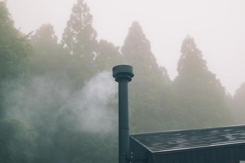 a light pole on top of a house in the fog at Earthboat Togakushi in Nagano