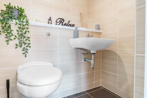 a bathroom with a toilet and a sink at Waterfront Luxury Apartment in Liverpool