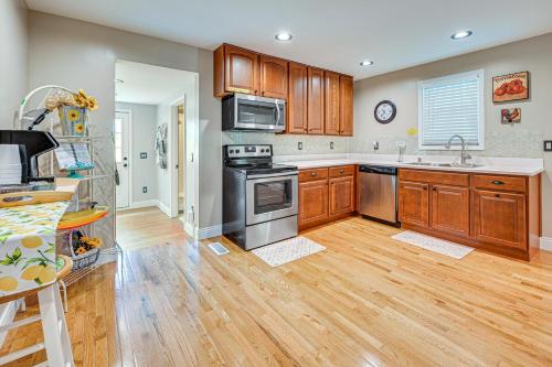 a kitchen with wooden cabinets and stainless steel appliances at Peaceful Murray Home about 8 Mi to Kentucky Lake! in Murray