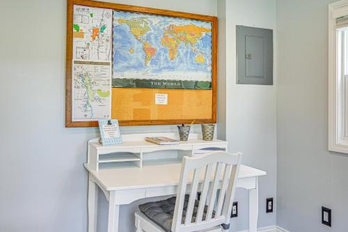 a desk with a white chair and a map on the wall at Peaceful Murray Home about 8 Mi to Kentucky Lake! in Murray