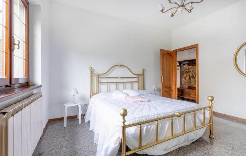 a bedroom with a bed with white sheets and a mirror at 3 Bedroom Nice Home In Fivizzano in Fivizzano