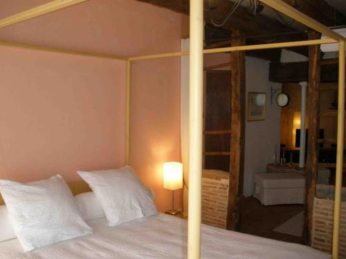 a bedroom with a bed with white pillows at Les Terraces Sur La Dordogne in Sainte-Foy-la-Grande