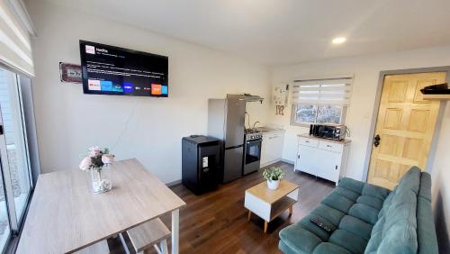 a living room with a couch and a table at Cabañas Las antenas in Coihaique