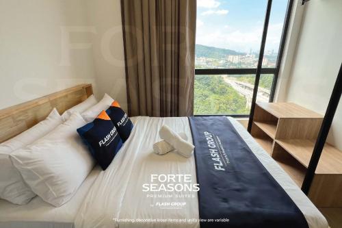 a hotel room with a bed with a large window at Forte Seasons Mossaz Premium Suites Petaling Jaya in Petaling Jaya