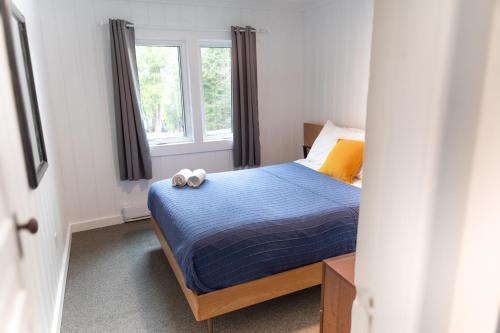a bedroom with a bed with two towels on it at Bonnie View Inn in Haliburton