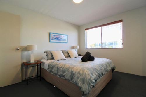 a bedroom with a bed with a teddy bear on it at Simply The Best, Couple Getaway in Huskisson in Huskisson