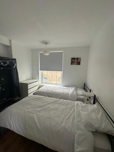 a bedroom with two beds and a window at Great location room in central London - Waterloo in London