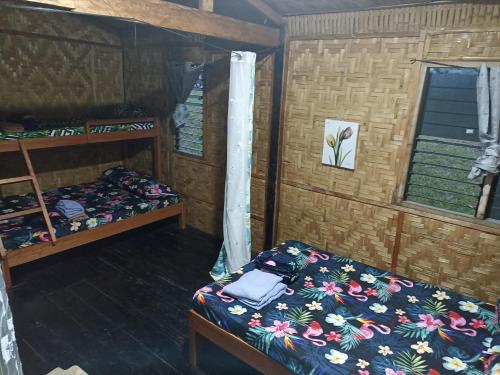 a room with a bed and a bunk bed at Davao City-Marilog Peak Cafe- Traveler's Staycation in Davao City