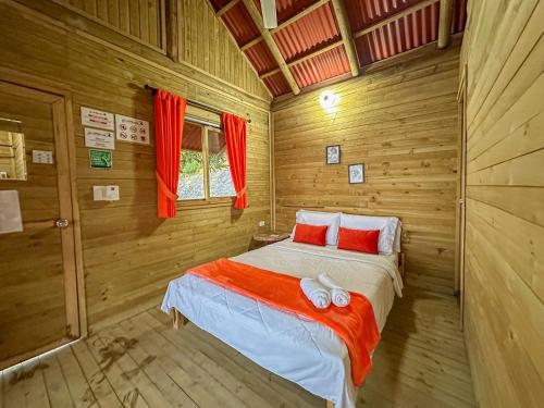 a bedroom with a bed in a wooden room at Loma Nevada Minca Hotel in Minca