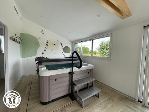 a small room with a bed and a sink at Maison spacieuse avec spa et sauna, proche centre-ville, plages et sites touristiques de Vendée - FR-1-426-558 in La Roche-sur-Yon