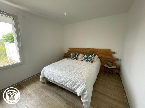 a bedroom with a bed and a window at Maison spacieuse avec spa et sauna, proche centre-ville, plages et sites touristiques de Vendée - FR-1-426-558 in La Roche-sur-Yon