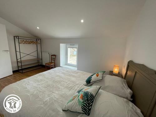 a bedroom with a large bed with pillows on it at Maison spacieuse avec spa et sauna, proche centre-ville, plages et sites touristiques de Vendée - FR-1-426-558 in La Roche-sur-Yon