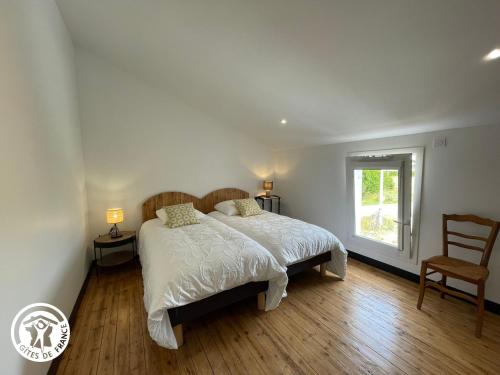 a bedroom with a bed and a chair and a window at Maison spacieuse avec spa et sauna, proche centre-ville, plages et sites touristiques de Vendée - FR-1-426-558 in La Roche-sur-Yon