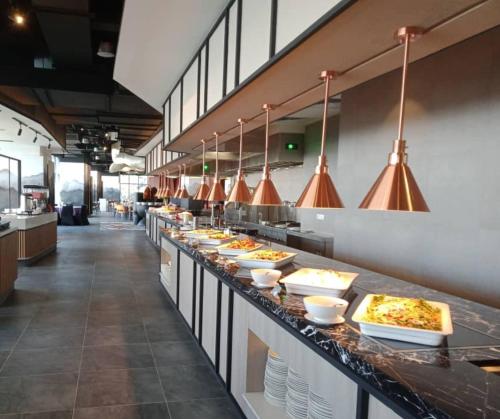 a buffet line with many plates of food at Wyndham Ion Majestic Genting Highlands in Genting Highlands