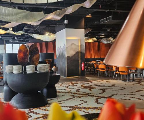 a dining room with a table with plates on a table at Wyndham Ion Majestic Genting Highlands in Genting Highlands