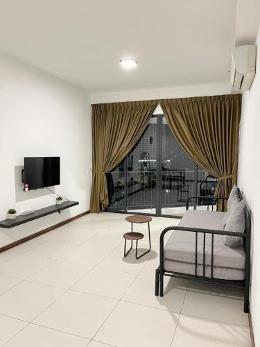 a living room with a bed and a tv at The Landmark Comfort Relax Spacious Sea View By IZ in Tanjong Tokong