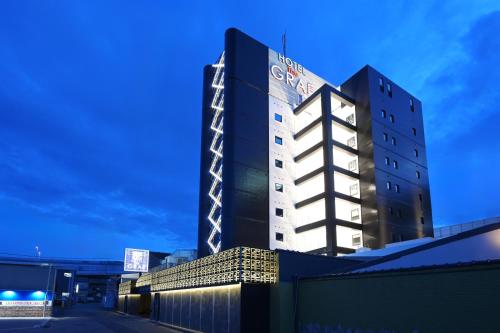 a building with a sign on the side of it at HOTEL The GRAF Matsubara in Miyake