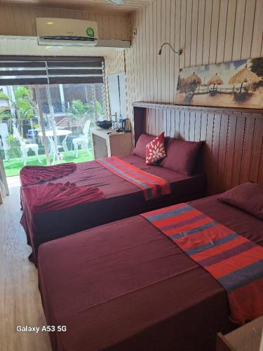 a bedroom with two beds and a window with a table at THE WISH RESIDENCE Kollupitiya,SeaSide Next To Marino beach Hotel,Colombo 3 in Colombo