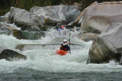 two people in a raft in rapids on a river at Omega Tours Eco-Jungle Lodge in La Ceiba