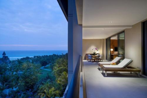 a balcony of a building with a view of the ocean at Raffles Hainan Clear Water Bay in Sanya
