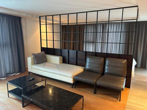 a living room with a couch and a coffee table at Sungsan Marina Hotel in Seogwipo