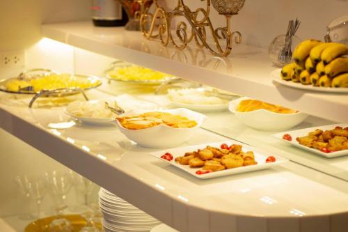 a buffet with different types of food on a shelf at Hoa Hong Hotel - Xa Dan in Hanoi