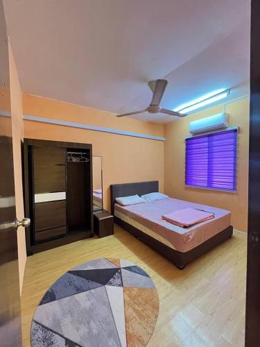 a bedroom with a bed and a window with a purple blind at Al-Hijrah Homestay Meru Klang in Kapar