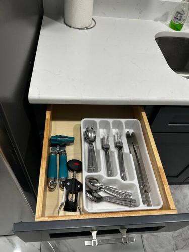 a drawer filled with utensils in a kitchen at Private Studio Suite in Central Orlando With Full kitchen in Orlando