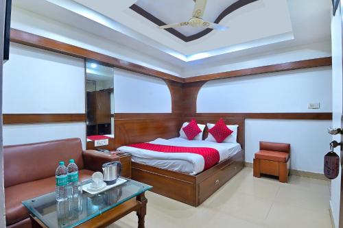 a bedroom with a bed and a couch and a table at Hotel Maharani -New Delhi Railway Station - Paharganj in New Delhi