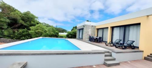 a swimming pool on the patio of a house at Casa Azul Terceira Island Azores in Fonte Bastardo