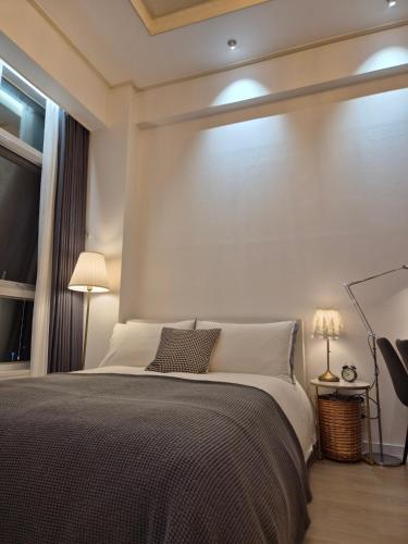 a bedroom with a large bed and a window at Sunny House in Seoul