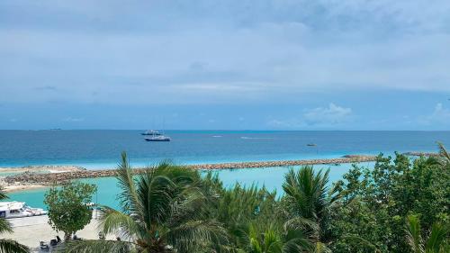 a view of the beach and ocean from a resort at iCom Marina Sea View in Maafushi