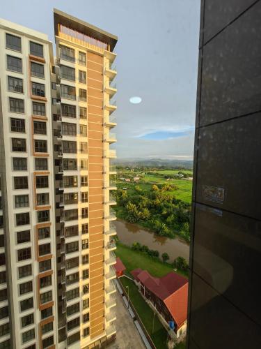 an aerial view of two tall buildings and a river at Near Airport K Avenue Family Room in Donggongon