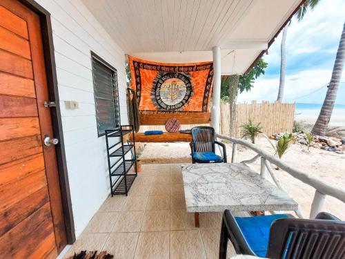 a balcony with a bed and a table and chairs at Last Hammock Beach Resort in Baan Khai