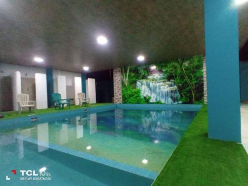 a large swimming pool in a building with a view at Habitación matrimonial con baño in Archidona
