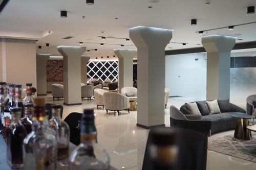 a lobby with chairs and wine bottles on a table at Expocore Hotel in Yerevan