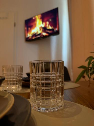 two glasses sitting on top of a wooden table at Cozy Apartment Wolke in Wuppertal