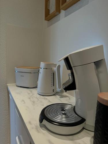 a counter top with a coffee maker and a mixer at Cozy Apartment Wolke in Wuppertal