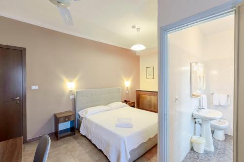 a bedroom with a bed and a sink and a toilet at Hotel Castello in Turin