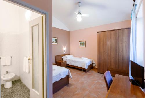 a hotel room with two beds and a television at Hotel Castello in Turin