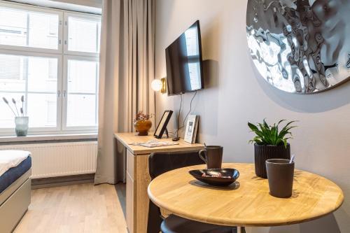 a room with a table and a desk with a computer at Unity Tampere - A Studio Hotel in Tampere