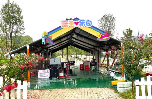a gas station with a sign on top of it at Zhangjiajie Cliff Flower RV Tent Hotel in Sanguansi