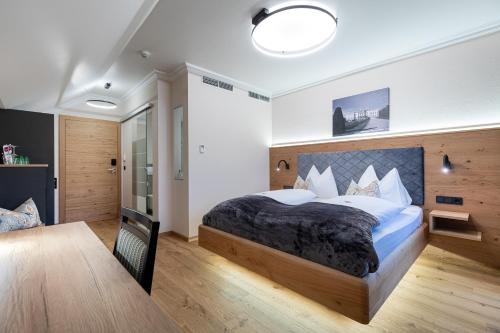 a bedroom with a large bed in a room at Design Hotel Frauenschuh in Salzburg