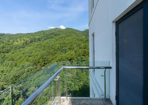 a balcony with a view of a mountain at Huangshan Taiping Lake Muxin Hotel in Fenghuangshan
