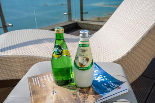 two bottles of beer sitting on top of a table at Huangshan Taiping Lake Muxin Hotel in Fenghuangshan