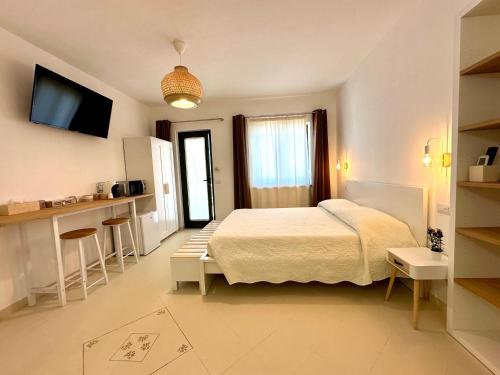 a bedroom with a bed and a kitchen in it at Lotto 16 - Guest House in Olbia