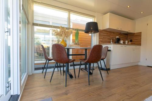 a kitchen with a table and chairs in a room at Houseboat Tomio NS001 near Amsterdam in Monnickendam