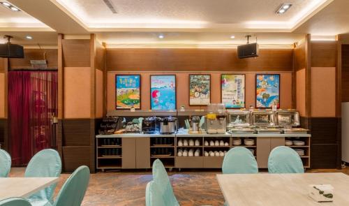 a restaurant with blue chairs and a counter at Fu Hsiang Hotel in Yilan City